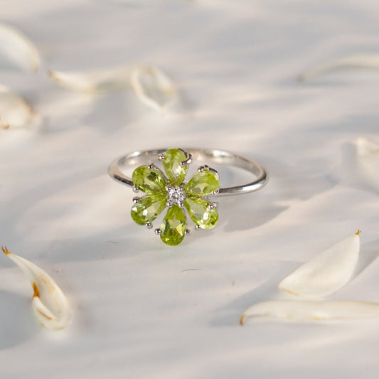 a green gemstone ring with a blurred background