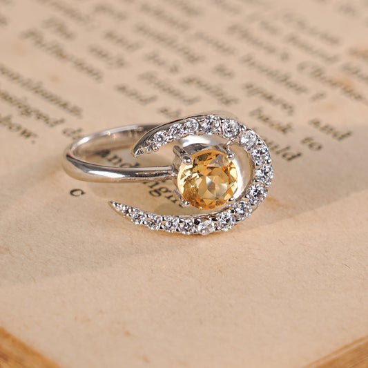 A crescent moon ring with a citrine center stone.