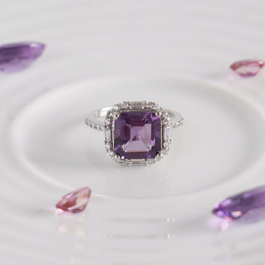 A sterling silver ring with an asscher-cut purple amethyst gemstone.
