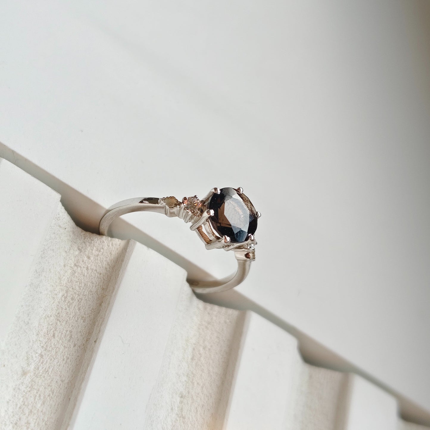Ring with a prominent gemstone on a white background