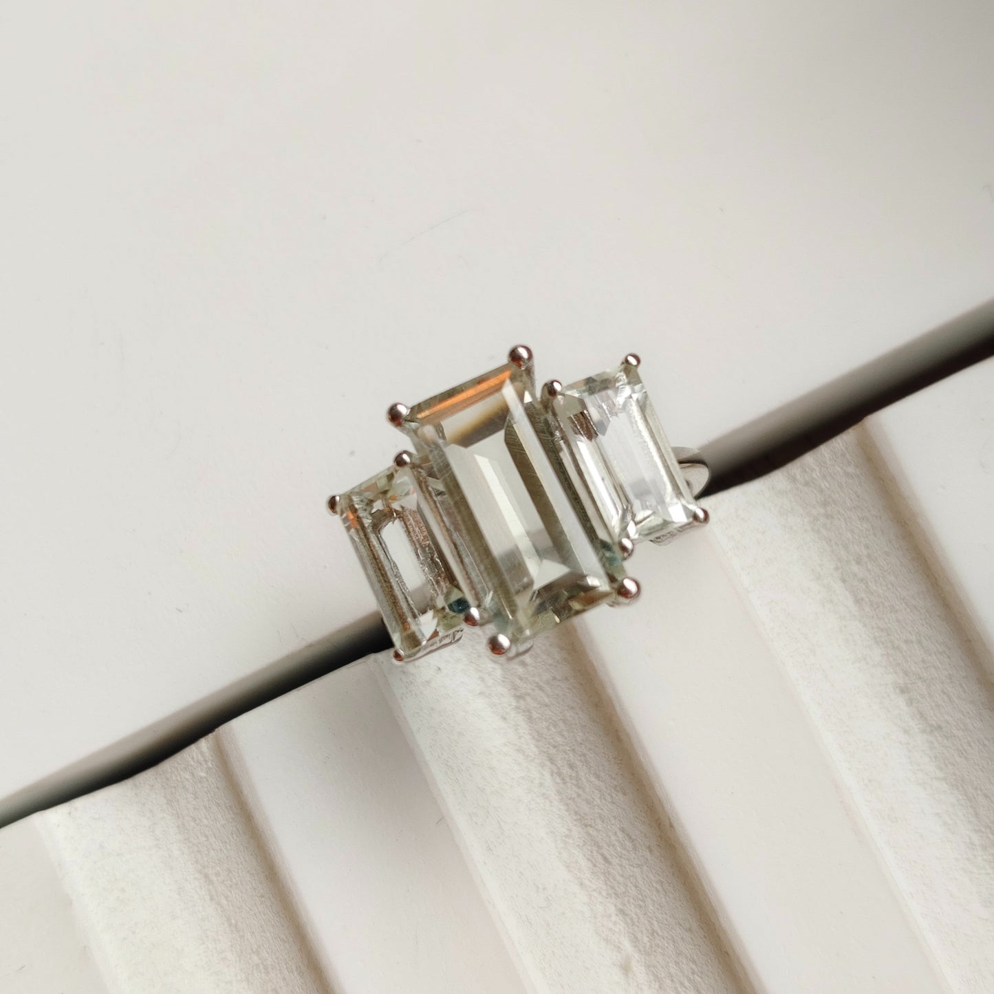 Pair of emerald-cut gemstone earrings on a white background