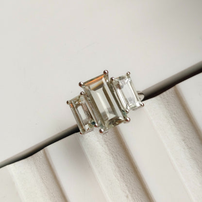Pair of emerald-cut gemstone earrings on a white background